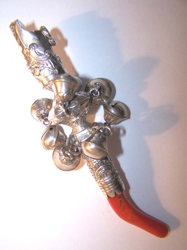 An exceptionally fine late 18th century Silver Child's Rattle with eight bells, a whistle and coral stem.